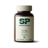 Image of E-Z Mg bottle next to tablets of magnesium supplements.